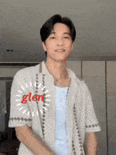a man wearing a white shirt with the word glen written on it
