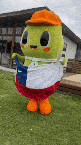 a green mascot is holding a mexican flag