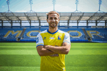 a man in a yellow and blue jersey with the word arnia on the sleeve