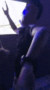 a person standing in front of a screen with a green light behind them