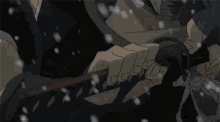 a person holding a sword in their hand with snow falling around them
