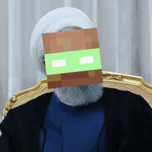 a man with a beard and a white turban has a minecraft mask on his face