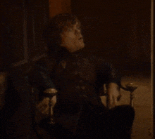 a man is sitting in a chair with the words well make do