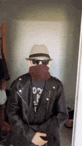a man wearing a hat and sunglasses is wearing a shirt that says daddy