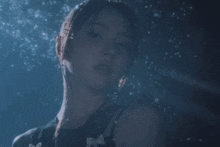 a close up of a woman 's face in the dark