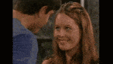 a man and a woman are looking into each other 's eyes and the woman is laughing .