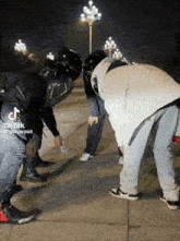 a tik tok video of a man wearing a helmet and a supreme jacket