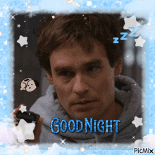 a picture of a man holding a cell phone with the words goodnight on it