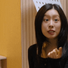 a woman in a black shirt is making a face