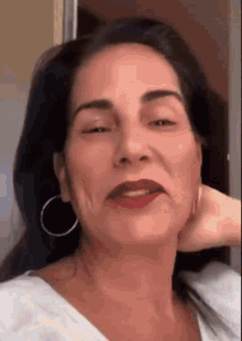 a close up of a woman 's face with her eyes closed and red lipstick .