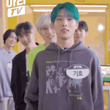 a group of young men standing in front of a sign that says tv