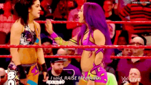 two women wrestling in a ring and one of them says " raise my hands "