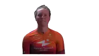 a woman wearing an orange shirt that says human powered health makes a funny face