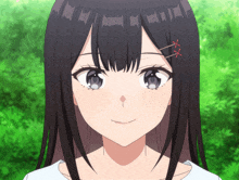 a close up of a girl 's face with long black hair