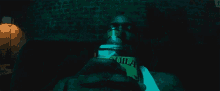 a man holds a bottle of quila in his hand