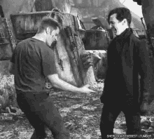 a black and white photo of two men standing next to each other with the caption sherlock is the best tumblr