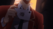 a man in a red suit is holding a piece of paper that says ' x ' on it