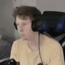 a young boy wearing headphones is sitting in front of a computer .