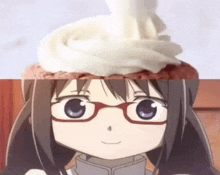 a girl with glasses is looking at a cupcake with whipped cream on it .