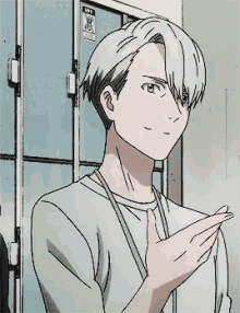 a man with white hair is standing in front of a locker room .