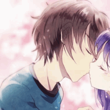 a boy and a girl are kissing in front of a pink background . the girl has purple hair .