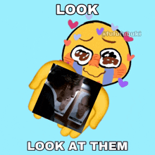 a yellow smiley face holding a picture of a man and the words look at them