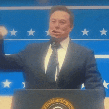 a man stands at a podium with the president of the united states seal on it