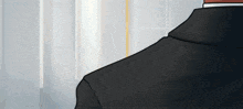 a man in a suit and tie is standing in front of a window in a room .