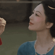 a woman with chinese writing on her face looks at a man