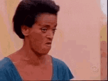 a close up of a woman making a funny face .