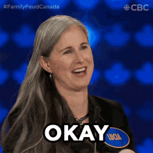 a woman with long gray hair says okay