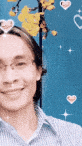a man with glasses and hearts around his head smiles