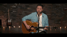a man playing a guitar and singing into a microphone that says taylor