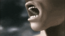a close up of a person 's mouth with their mouth open and teeth visible .
