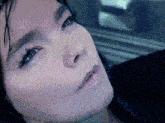 a close up of a woman 's face with her eyes closed and her mouth open .