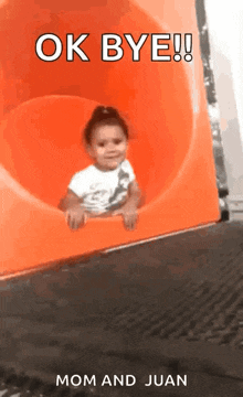 a little girl is sliding down an orange slide with the words ok bye mom and juan below her .