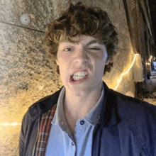 a young man making a funny face with his mouth open