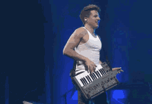 a man in a white tank top is playing a keyboard that says lux n3