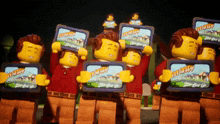 a group of lego figures are holding up a sign that says ' stay happy '