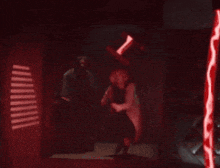 a woman in a white coat is standing in a dark room with a red light behind her