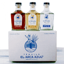 three bottles of el arca azul tequila are sitting on top of a box