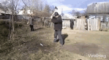 a man is swinging an axe in a yard and the video is being shared on viralhog