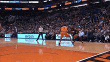 a basketball game is being played in front of a verizon banner
