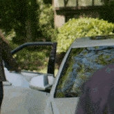 a woman is getting out of a car with her door open