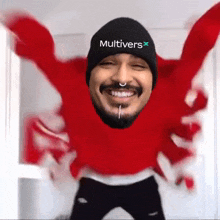 a man wearing a red sweater and a black hat with the word multivers on it
