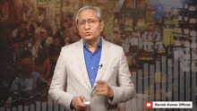 a man in a suit stands in front of a graph that says ravish kumar official on the bottom
