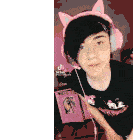 a young man wearing pink headphones and a black shirt with a sticker on it
