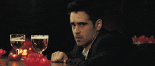 a man toasting with a glass of beer and a bowl of strawberries