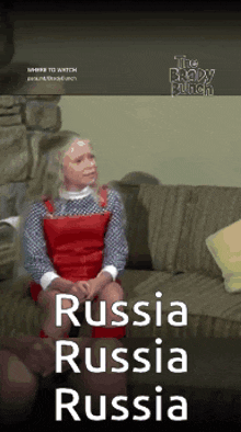 a woman is sitting on a couch with the words " russia russia russia " on the bottom