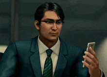 a man in a suit and tie is holding a phone
